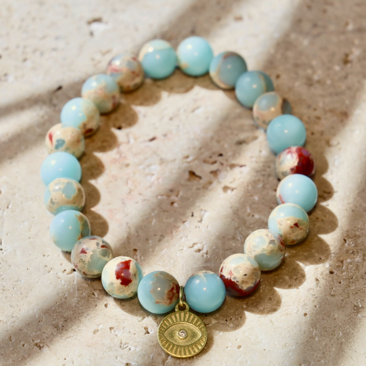 light blue agalmatolite gemstone bracelet with evil eye charm 